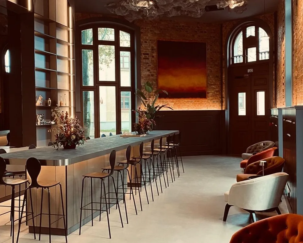 HIDE lobby with a long coffee bar under arched windows